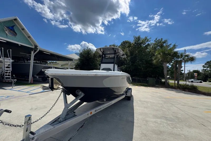 Slide: The Image of 2025 NauticStar 251 Hybrid boat on trailer under clear blue sky. - 5