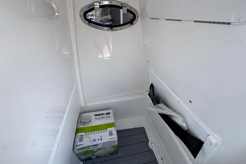 Slide: The Image of Interior of 2025 NauticStar 251 Hybrid boat with Thetford Porta Potti. - 28