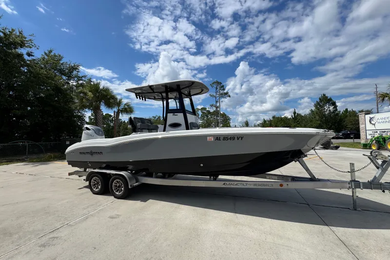 Slide: The Image of 2025 NauticStar 251 Hybrid boat on trailer under a partly cloudy sky. - 9