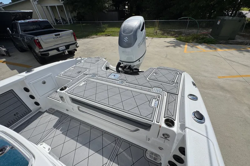Slide: The Image of 2025 NauticStar 251 Hybrid boat with Suzuki outboard motor in a driveway. - 40