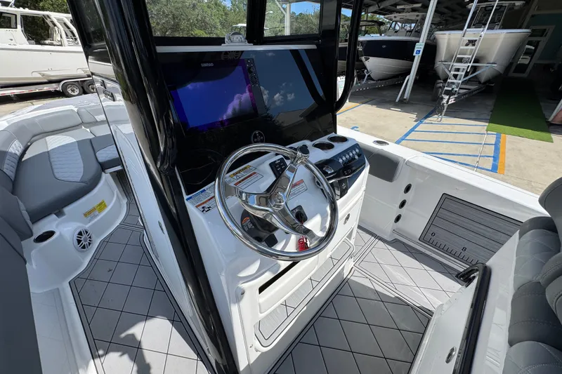 Slide: The Image of 2025 NauticStar 251 Hybrid boat interior with modern steering console and seating. - 33