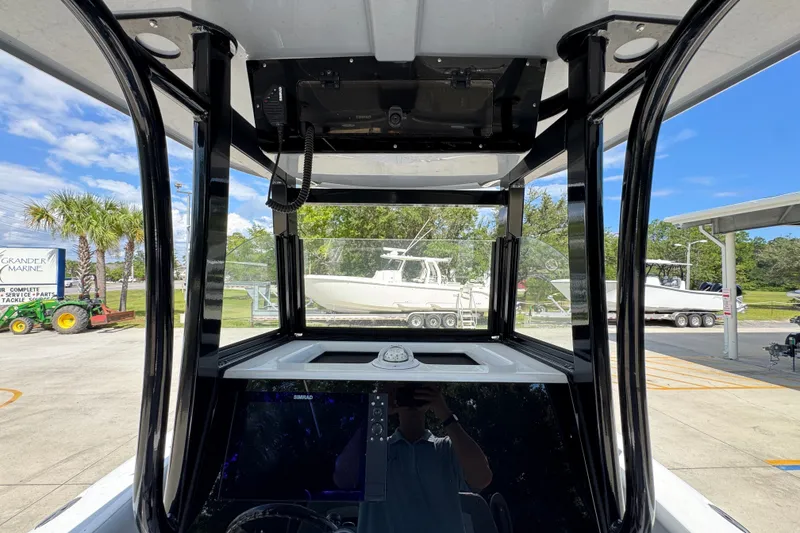 Slide: The Image of 2025 NauticStar 251 Hybrid boat interior with console and windshield view. - 35