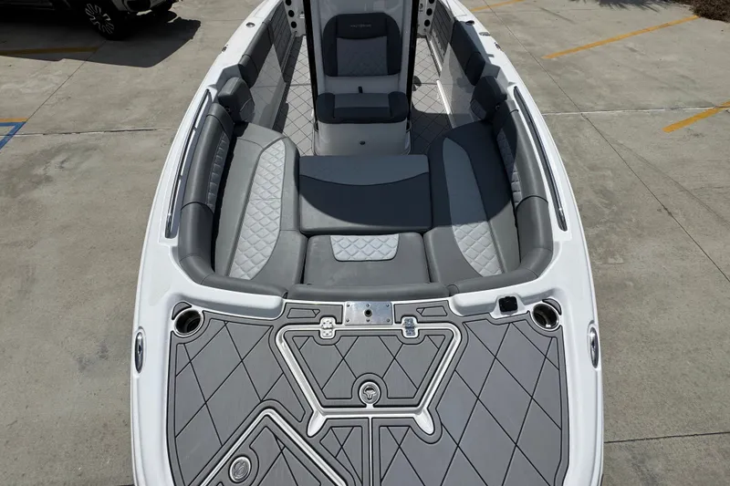 Slide: The Image of 2025 NauticStar 251 Hybrid boat interior with gray cushioned seating and sleek design. - 23