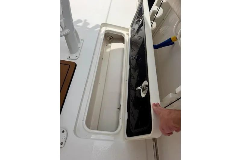Slide: The Image of Open storage compartment on 2022 Tidewater 272 CC Adventure boat. - 11