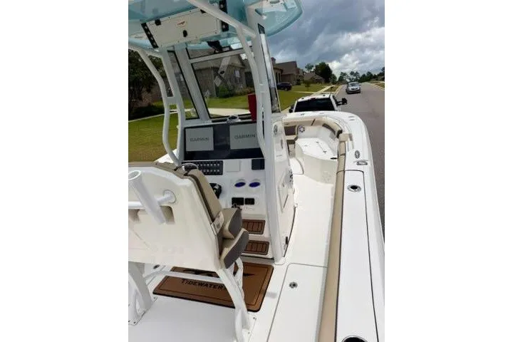 Slide: The Image of 2022 Tidewater 272 CC Adventure boat with dual Garmin displays, parked on a residential street. - 16
