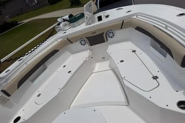 Slide: The Image of 2022 Tidewater 272 CC Adventure boat deck with seating and storage compartments. - 9