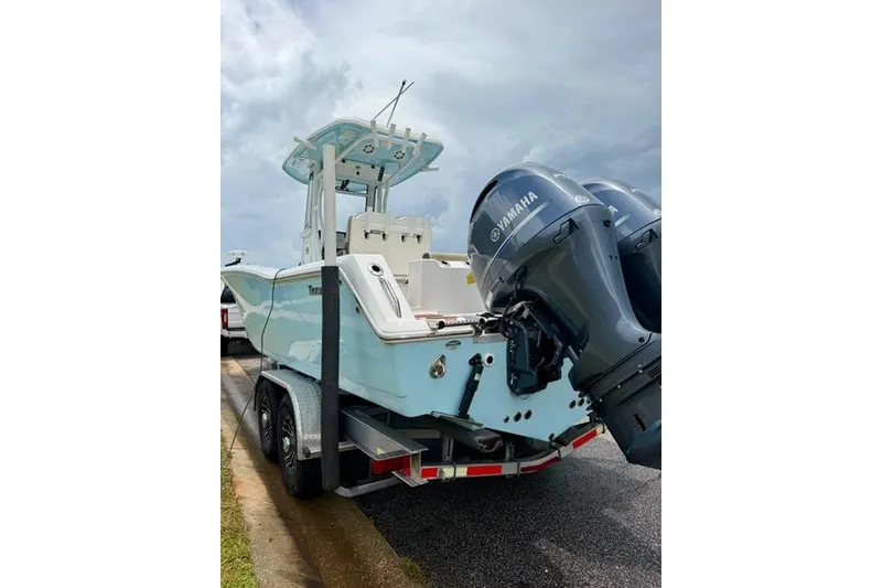 Slide: The Image of 2022 Tidewater 272 CC Adventure boat with dual Yamaha engines on a trailer. - 5