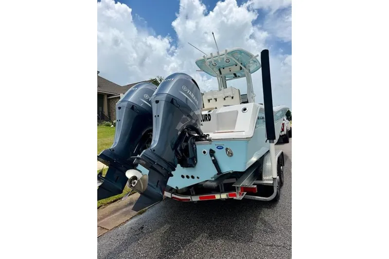 Slide: The Image of 2022 Tidewater 272 CC Adventure boat with dual Yamaha outboard engines on a trailer. - 6