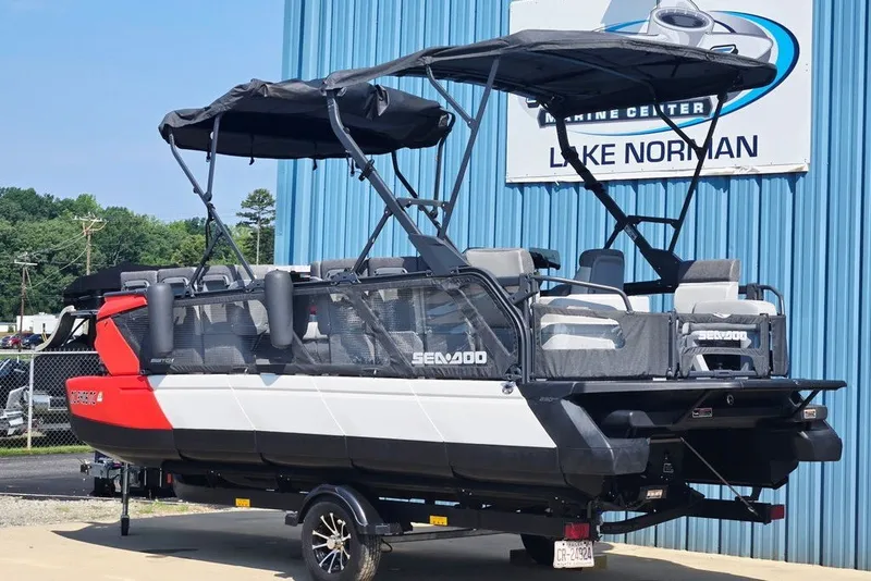 Slide: The Image of 2023 Sea-Doo Switch Cruise 21 pontoon boat with canopy, parked at Lake Norman Marine Center. - 24