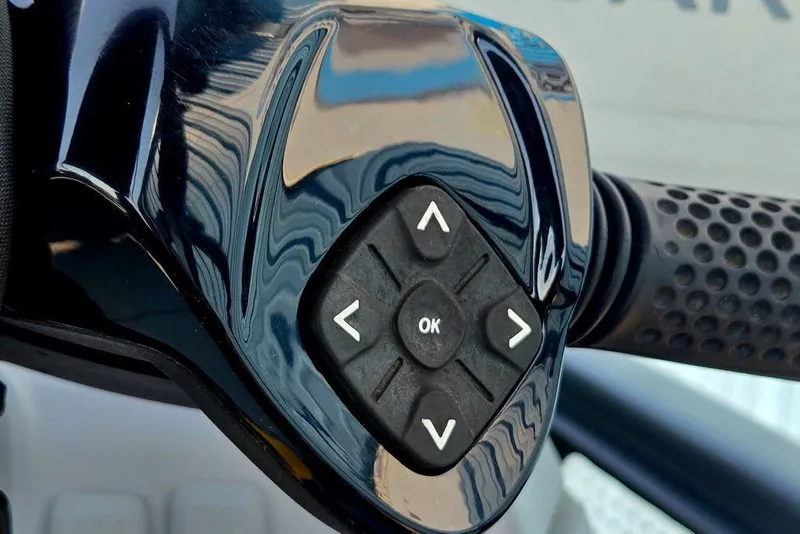 Slide: The Image of Close-up of 2023 Sea-Doo Switch Cruise 21 handlebar controls with directional buttons. - 38