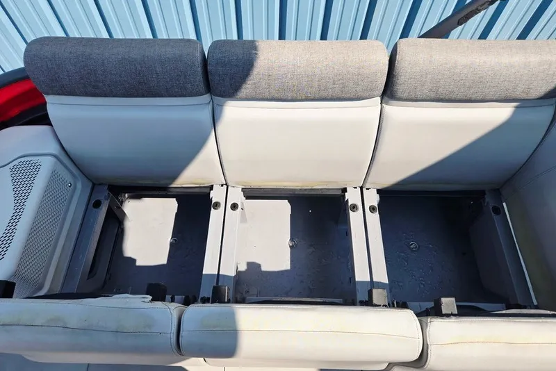 Slide: The Image of 2023 Sea-Doo Switch Cruise 21 seating area with gray cushions and storage compartments. - 18