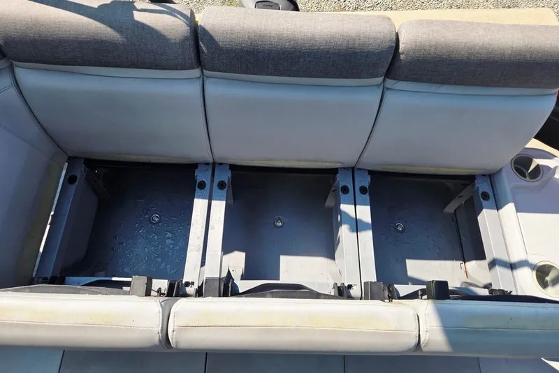 Slide: The Image of 2023 Sea-Doo Switch Cruise 21 boat seating with storage compartments open. - 21