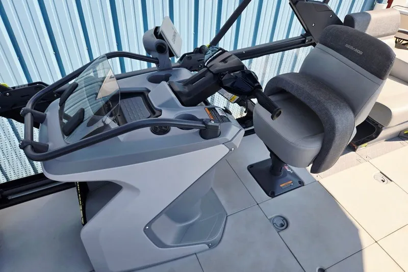 Slide: The Image of 2023 Sea-Doo Switch Cruise 21 helm with steering wheel and comfortable seating. - 26