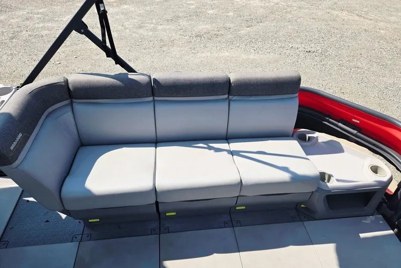 Slide: The Image of 2023 Sea-Doo Switch Cruise 21 interior seating with gray upholstery and cup holders. - 23