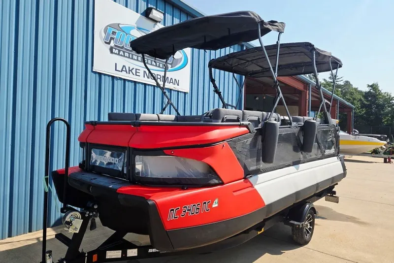 Slide: The Image of 2023 Sea-Doo Switch Cruise 21 pontoon boat parked at Lake Norman marine center. - 10