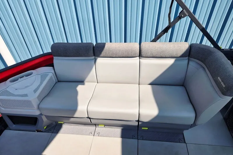 Slide: The Image of 2023 Sea-Doo Switch Cruise 21 interior seating with gray upholstery and cup holders. - 22