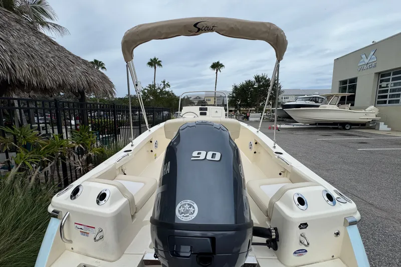 Slide: The Image of 2027 Scout 188 Sportfish boat with Yamaha 90 engine, parked outdoors near palm trees. - 12