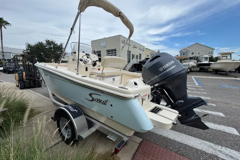 Slide: The Image of 2027 Scout 188 Sportfish boat with Yamaha engine, parked outdoors near dealership. - 5