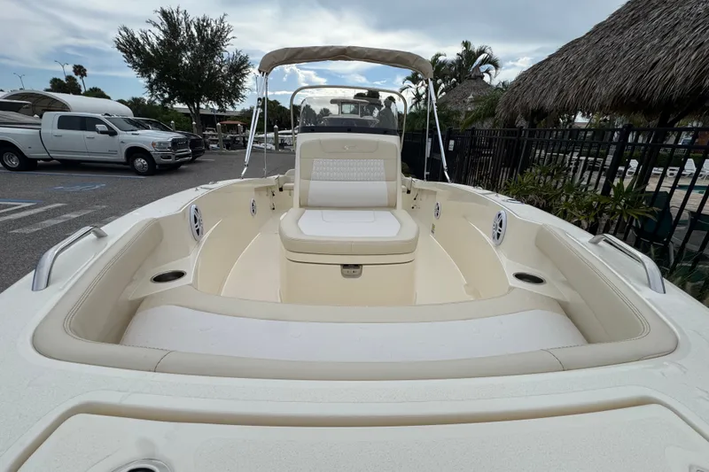 Slide: The Image of 2027 Scout 188 Sportfish boat with spacious seating and sleek design in a marina setting. - 6