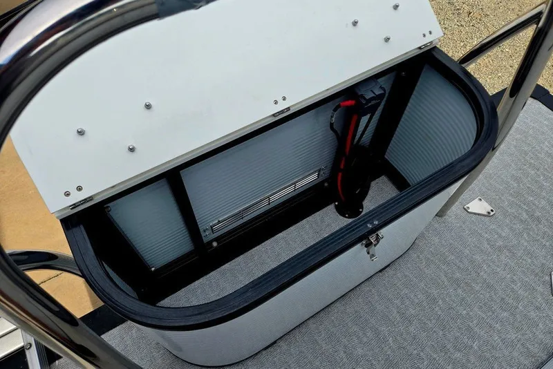 Slide: The Image of Open storage compartment on a 2020 Tahoe 225 boat, featuring a sleek design and secure latch. - 46