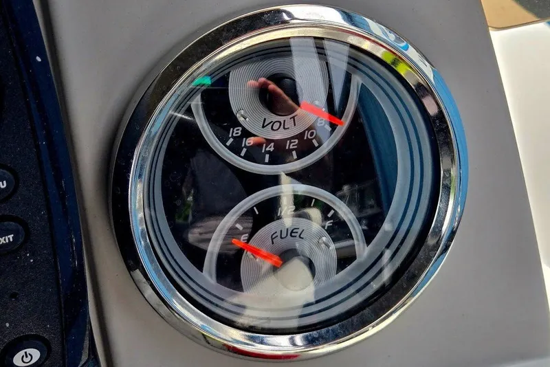 Slide: The Image of Dashboard gauges of a 2020 Tahoe 225 boat, displaying voltage and fuel levels. - 14