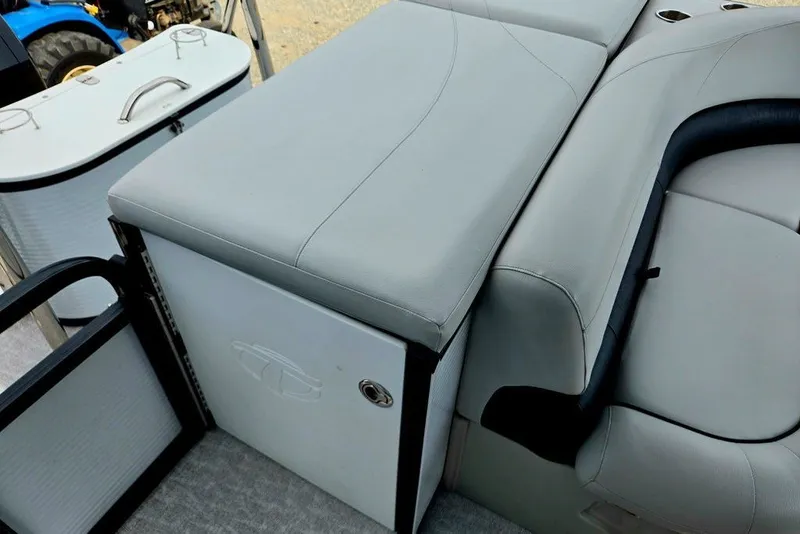 Slide: The Image of Interior seating of a 2020 Tahoe 225 boat with gray upholstery and storage compartments. - 26