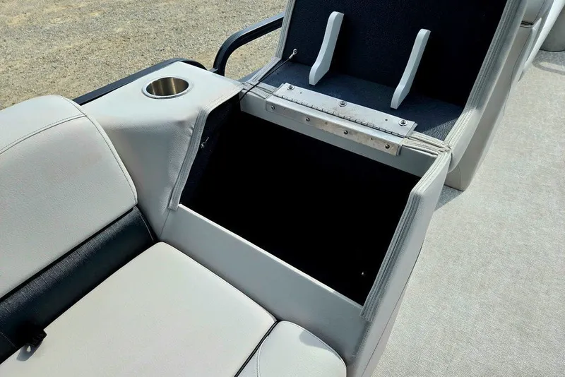 Slide: The Image of 2020 Tahoe 225 boat interior with open storage compartment and cup holder. - 34