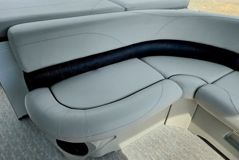 Slide: The Image of 2020 Tahoe 225 boat interior with sleek, curved gray seating and black accents. - 25