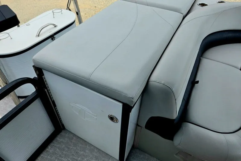 Slide: The Image of 2020 Tahoe 225 boat interior with cushioned seating and storage compartment. - 44