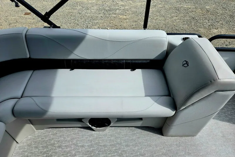 Slide: The Image of 2020 Tahoe 225 boat interior with gray cushioned seating and cup holder. - 30