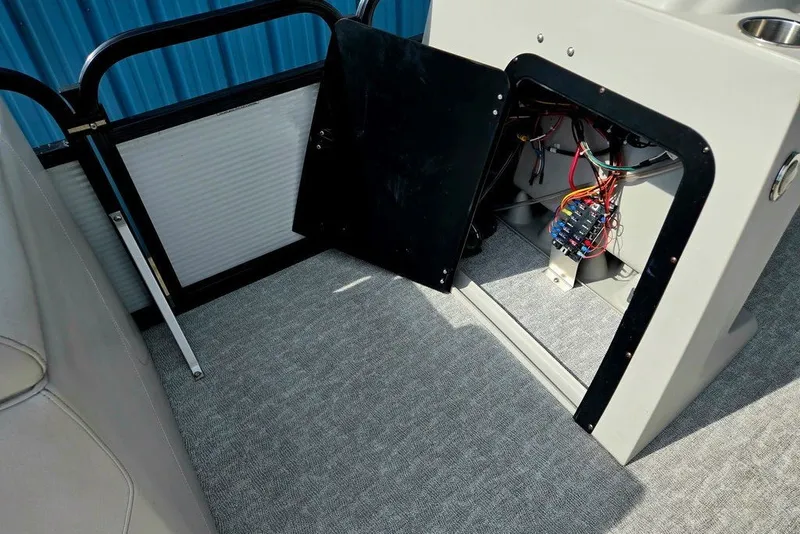 Slide: The Image of 2020 Tahoe 225 boat interior showing open electrical panel with wiring. - 20