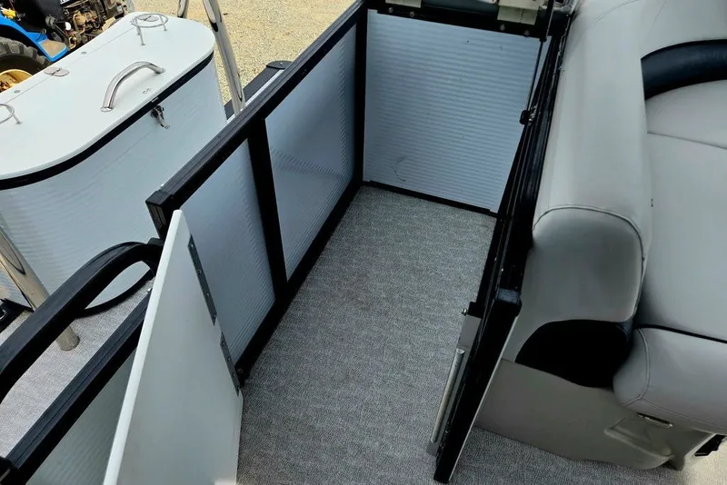 Slide: The Image of Interior of a 2020 Tahoe 225 boat, featuring seating and storage area. - 36
