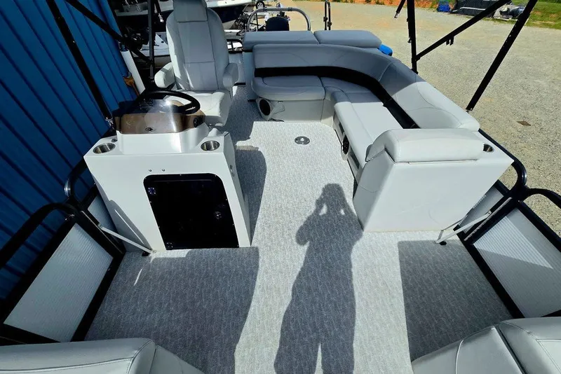 Slide: The Image of Interior of 2020 Tahoe 225 boat with gray seating and carpeted floor. - 18