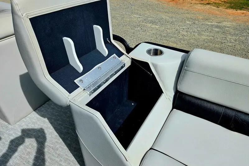 Slide: The Image of Open storage compartment in 2020 Tahoe 225 boat seat with cup holder. - 22