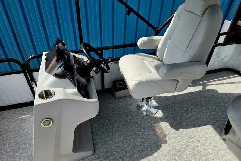 Slide: The Image of 2020 Tahoe 225 boat interior with captain's chair and steering console. - 24