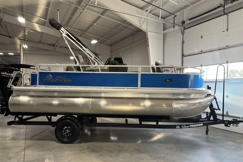 The Image of 2027 Sun Tracker Bass Buggy 18 DLX pontoon boat in a showroom setting. - 0