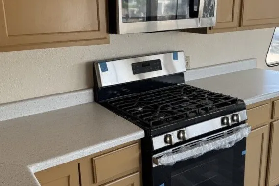 Slide: The Image of Modern kitchen with stainless steel stove, microwave, and beige cabinets. Masterfab 65, 1982 model. - 3
