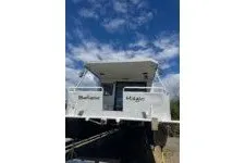 Slide: The Image of 1982 Masterfab 65 houseboat under a clear blue sky. - 1