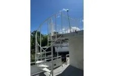 Slide: The Image of Outdoor spiral staircase on a Masterfab 65 houseboat, 1982 model, under clear blue sky. - 6