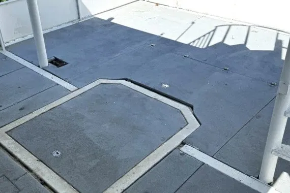 Slide: The Image of Flat deck of 1982 Masterfab 65 boat with hatch and railing shadows. - 7