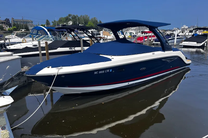 The Image of 2020 Sea Ray SLX 280 boat docked in a marina, featuring a sleek blue design. - 0
