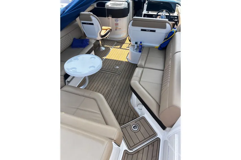 Slide: The Image of Interior of a 2020 Sea Ray SLX 280 boat with beige seating and wooden flooring. - 15