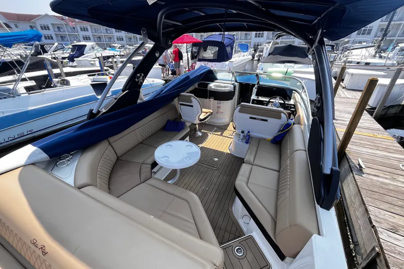Slide: The Image of 2020 Sea Ray SLX 280 boat interior with luxurious seating at a marina. - 16