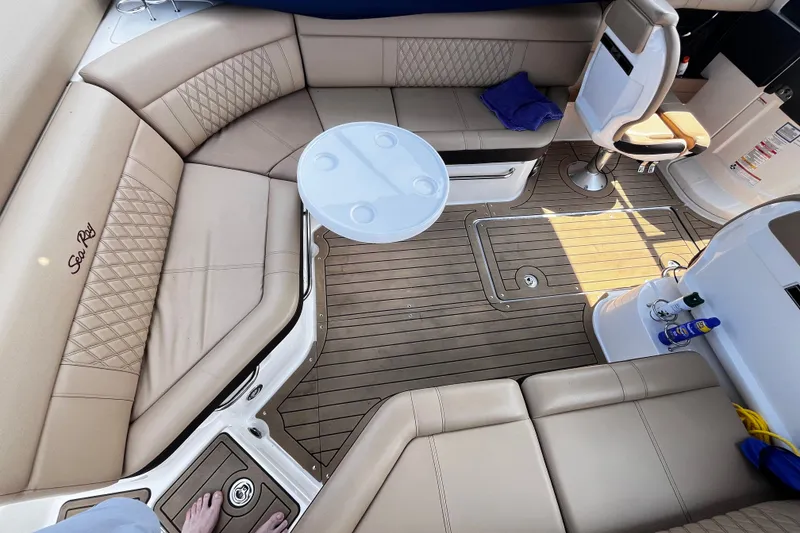 Slide: The Image of Luxurious interior of 2020 Sea Ray SLX 280 boat with beige seating and wooden flooring. - 17