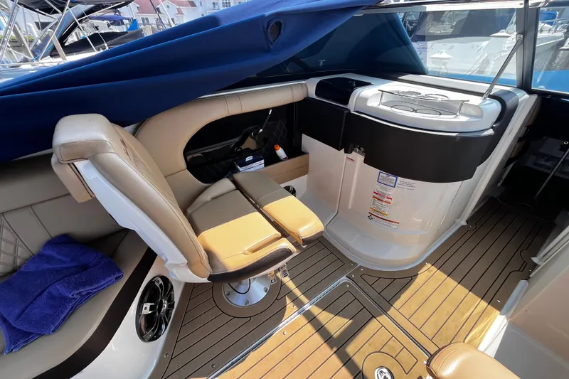 Slide: The Image of 2020 Sea Ray SLX 280 interior with seating and helm, featuring elegant design and wood flooring. - 18