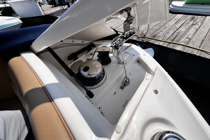 Slide: The Image of Open anchor compartment of 2020 Sea Ray SLX 280 boat, showcasing winch and chain mechanism. - 14