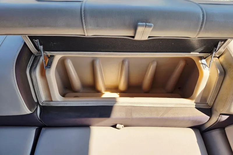 Slide: The Image of 2018 Sun Tracker Party Barge 22 XP3 storage compartment with open lid, showcasing interior space. - 37