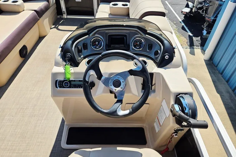Slide: The Image of 2018 Sun Tracker Party Barge 22 XP3 dashboard with steering wheel and controls. - 22