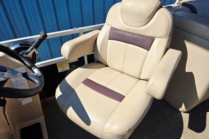 Slide: The Image of Captain's chair on 2018 Sun Tracker Party Barge 22 XP3, featuring beige upholstery and armrests. - 30