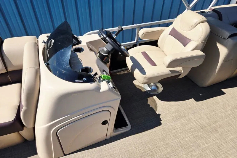 Slide: The Image of 2018 Sun Tracker Party Barge 22 XP3 helm with beige captain's chair and steering console. - 23